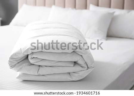 Soft folded blanket on bed at home Royalty-Free Stock Photo #1934601716