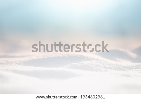 SNOW, ICE AND COLD LIGHT BLUE SKY BACKGROUND