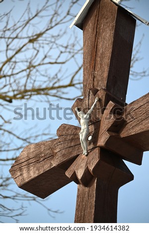wooden brown painted cross with a crucifix figure