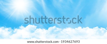 Blue sky with light clouds and bright sun. Wide summer sky backdrop Royalty-Free Stock Photo #1934627693