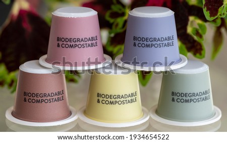 Close up of colourful, sustainable eco friendly coffee capsules. The pods are compostable and biodegradable. coleus leaves in the bacground.
 Royalty-Free Stock Photo #1934654522