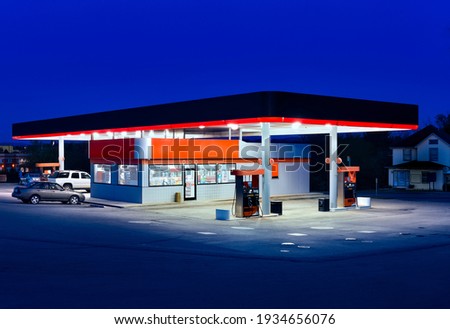 Horizontal shot of a generic gasoline station and convenience store at dusk. Royalty-Free Stock Photo #1934656076