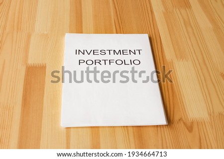 Empty space for text or logo. Investment portfolio on the table.