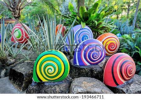 Colorful of sculpture snails in beautiful garden. Royalty-Free Stock Photo #193466711