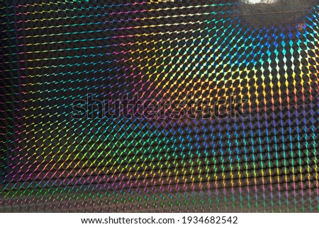 glitter grid pattern background, macro photo of silver rainbow holographic foil, colorful hologram surface.
