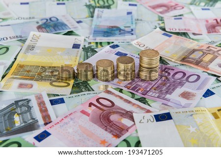 Euro banknotes and euro coins in simple example of rising euro prognoses.