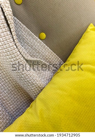textile details on furniture chairs, pillows and blankets in trendy colors ultimate gray and illuminating yellow