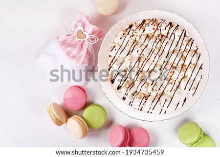 Cake with chocolate and meringue, marshmallow on a light table, festive food for mother's day, wedding, birthday. Modern bakery concept, advertising space, selective focus, delicious dessert. 