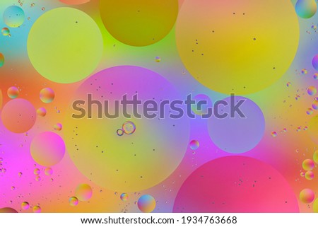 Bright Colorful Background Closeup of Oil Drops in Water. Creative Macro Photo of Liquid Surface with Circular Bubbles. Abstract Design of Colored Watery Texture.