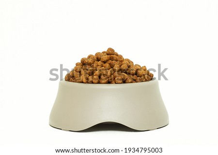 Kibble in pet bowl isolated on white Royalty-Free Stock Photo #1934795003