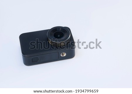 Compact action camera for shooting videos and photos on a white background