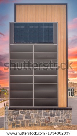 Tall decorative strip mall pylon, monument, advertisement billboard sign with no logos with enough brown panel space for 16 stores colorful orange sunset background, electric display wood panel