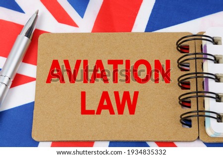 Law and justice concept. Against the background of the flag of Great Britain lies a notebook with the inscription - AVIATION LAW
