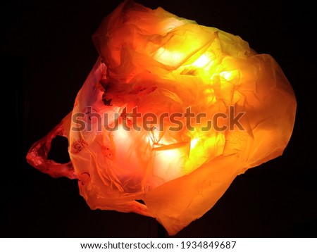 abstract illustration of fish from used plastic bag in orange color