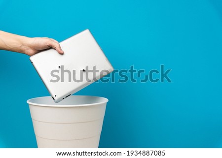 The tablet is thrown into the trash for disposal and recycling Royalty-Free Stock Photo #1934887085