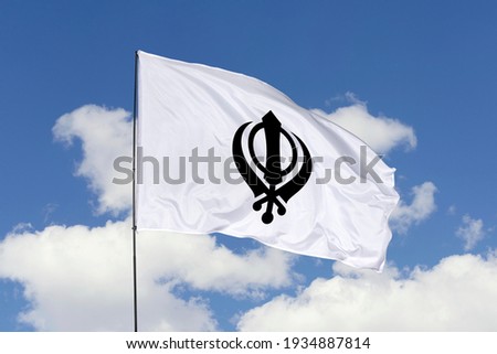 Sikhism flag isolated on sky background with clipping path. close up waving flag of Sikhism. flag symbols of Sikhism.