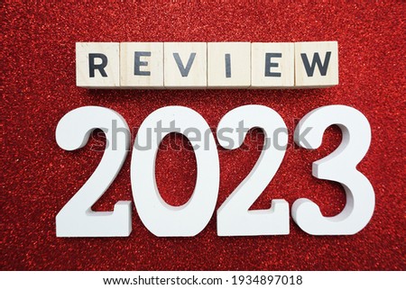 review 2023 word alphabet letters on red glitter background
