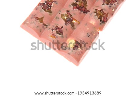 Bar of pink chocolate with raisins and fruits close-up