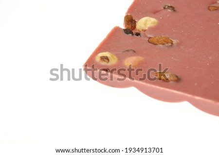 Bar of pink chocolate with raisins and fruits close-up