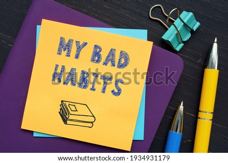  MY BAD HABITS text in search bar. Businessman looking at cellphone. 
