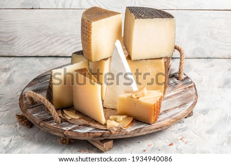 Petit Basque, French cheese, Cheese board of various types of soft and hard cheese. spanish manchego cheese. Royalty-Free Stock Photo #1934940086