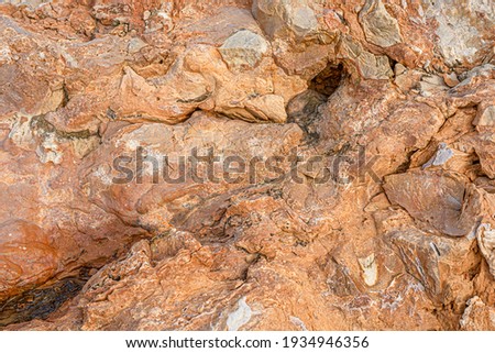 Light red-orange stone texture. Red orange grunge background. Mountain texture macro close-up. Bright colorful banner for your design. Hight quality photo