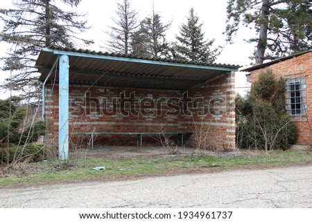 An old abandoned brick bus stop