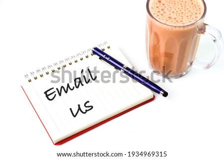 Pen and notebook written with text EMAIL US.