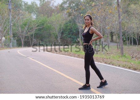 Portrait of young beautiful woman doing exercise outdoor in the morning.