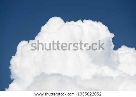 Clear blue sky with glowing white cumulus clouds after thunderstorm at sunset. Dramatic cloudscape. Concept art, meteorology, ecology, climate change, religion, heaven, hope, peace, graphic resources