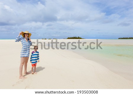happy smiling mother and her little son at the picture perfect beach, tropical vacation together