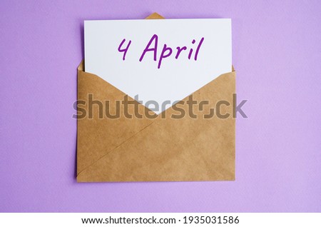 Kraft envelope with a white sheet of paper and the inscription April 4 on lilac background. Correspondence calendar and memorable date concept