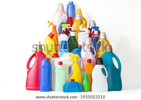 A lot of bottles with chemicals for cleaning. Pile of many colorful bottles on the white background with copy space for your text. Different plastic bottles in the form of mountain.  Royalty-Free Stock Photo #1935053210