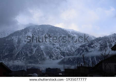 Steep and large mountains covered in heavy snow