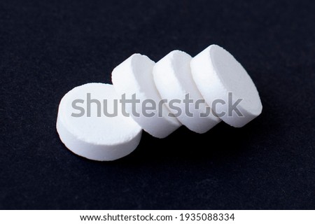 Medical pills and capsules. Isolated on a black background. A fast-dissolving, effervescent tablet, allergy pill, antibiotics. Virus and flu Diseases in Winter.