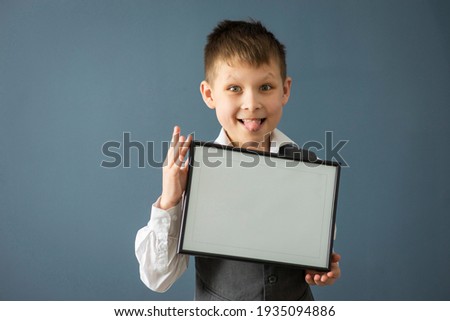 boy 8-10 years old in a white shirt on a dark background with a frame, space for text, selective focus