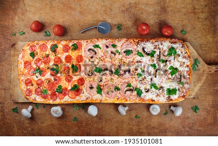 One Meter Long pizza.Long pizza mix lies on a wooden table. Roman pizza on a wooden spatula. one meter long. On a wooden pizza spatula.  Royalty-Free Stock Photo #1935101081