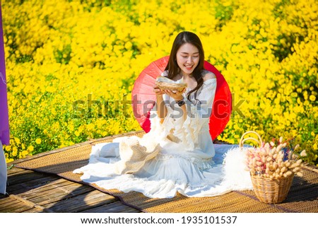 Beautiful asian girl Taking pictures in a flower farm. Happily in Chiang Mai, Thailand