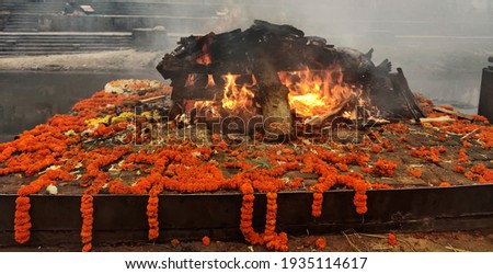 Burning Hindu funeral pyre, Hindu funeral rights of burning the body on a tall wooden funeral pyre in Nepal	 Royalty-Free Stock Photo #1935114617