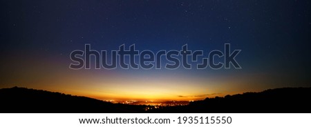 Night landscape with light from the city on the horizon Royalty-Free Stock Photo #1935115550