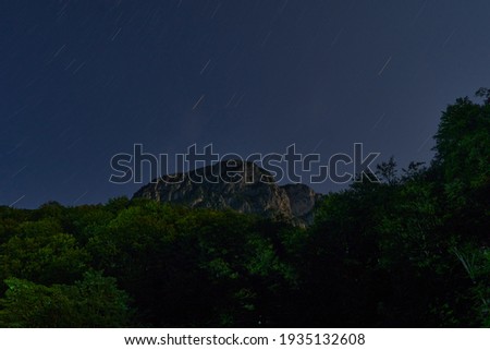 night photography of sky mountain and forest