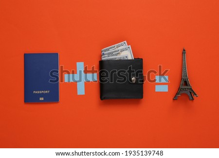 Travel concept. Equation with passport, wallet and eiffel tower on orange background