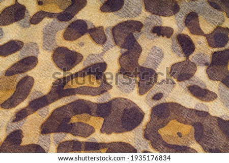 Orange and brown leopard spots pattern printed  on textile texture background