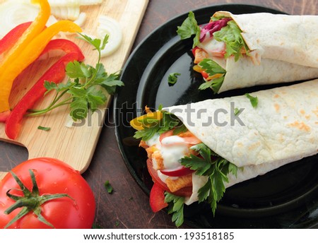 Wraps with fresh chicken and vegetables on a plate