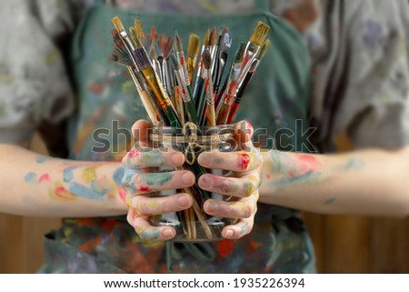 Woman's hand with paint brush. Royalty-Free Stock Photo #1935226394