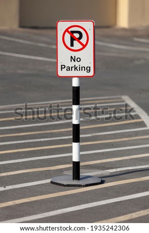 no parking sign in the empty parking lot on the hot sunny afternoon