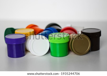 Close-up view ofcolorful gouache cans isolated on a white background. Drawing concept, children's creativity.
