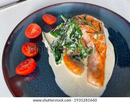 Food and delicious red fish trout cooked with milk sauces and on a beautiful plate
