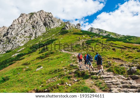 A view of the peaks Small Giewont and Giewont. Majestic mountain landscape in Tatras. Zakopane, Poland. Trekkers discover the world. Active lifestyle, sport and tourism. Royalty-Free Stock Photo #1935294611