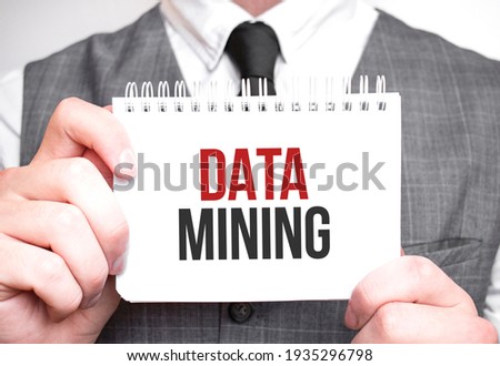 Businessman with notebook with text DATA MINING . Business concept
